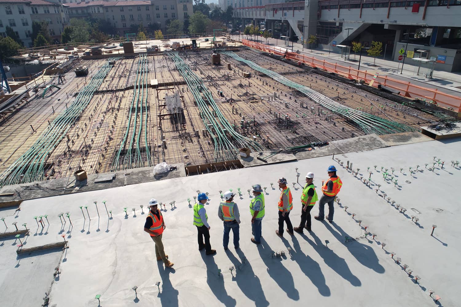 Wide view shoot with group of construction worker looking into a worksite